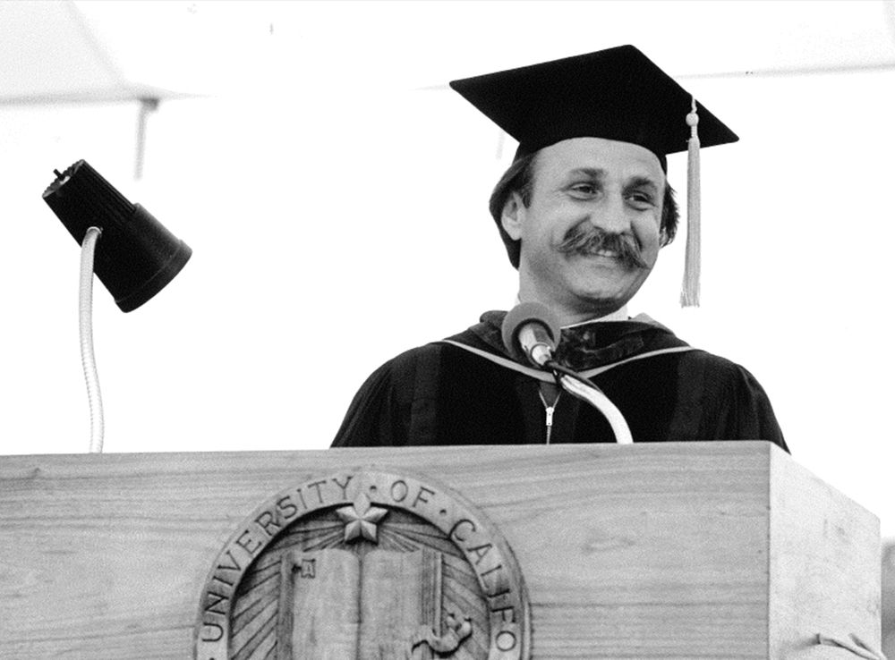 man at graduation lectern