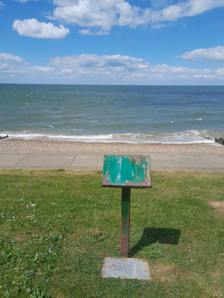 A signboard without words stands atop a small cliff in Kent.