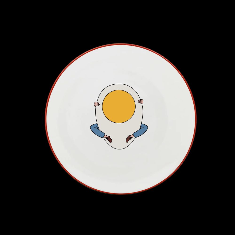 Plate from the Bouillon Pigalle restaurant in Paris. Red rimmed, this one has an egg with legs on it.