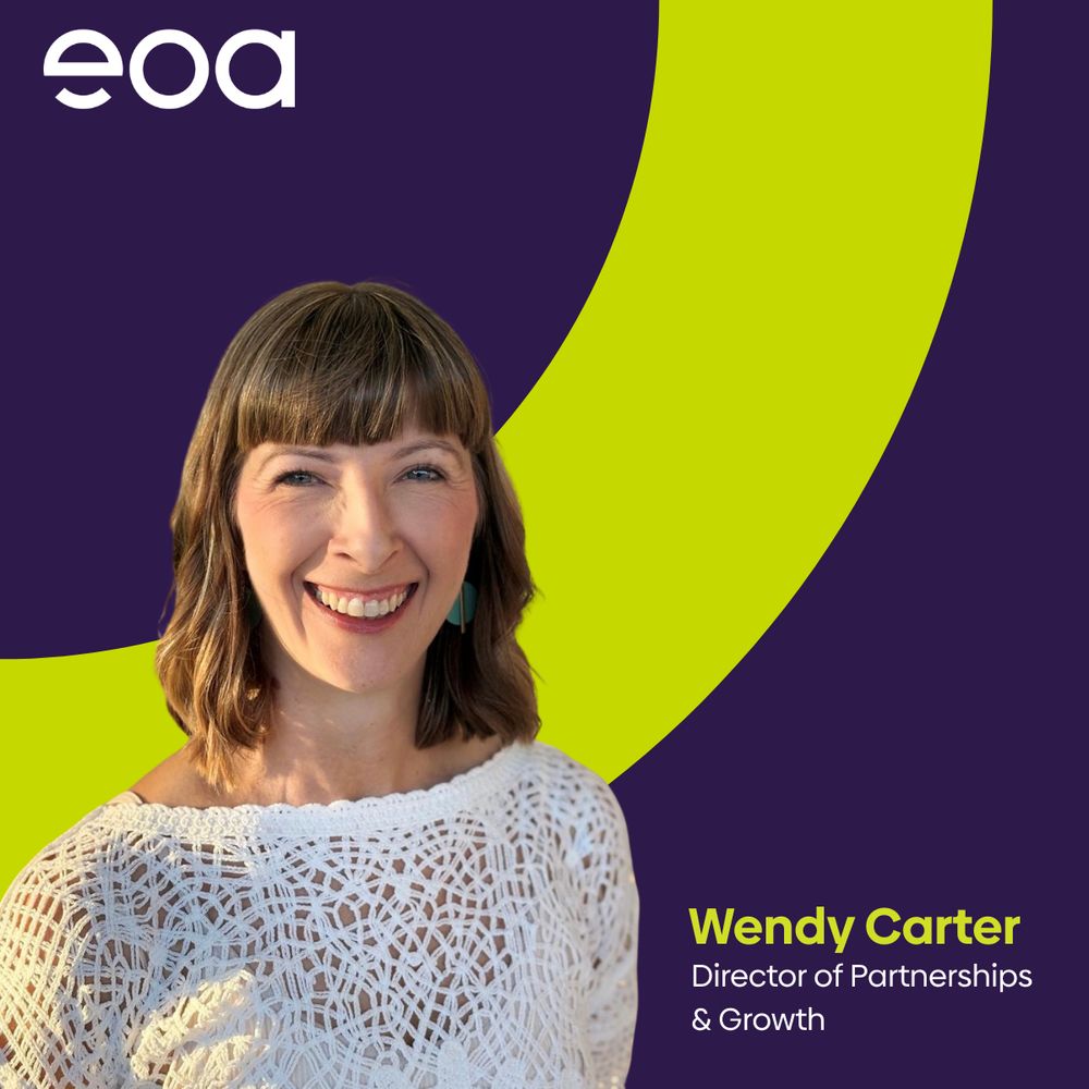 A smiling white woman in a white top with long brown hair. She is mounted on a dark purple background with a yellow arch-shaped graphic behind her. In the bottom right corner is text that reads 'Wendy Carter, Director of Partnerships & Growth'
