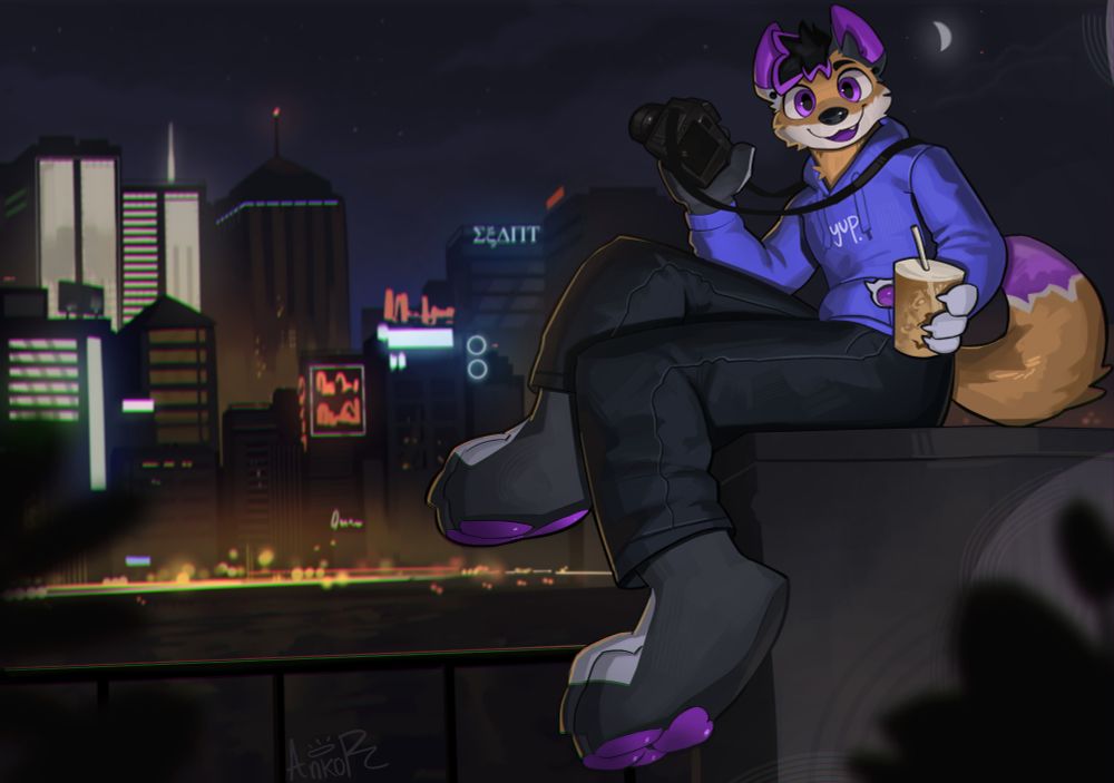 Scramble, a purple and orange fox with mismatched ears, is sitting in a wall, with a city lit up at night in the background. They're holding a camera and a cup of iced coffee.