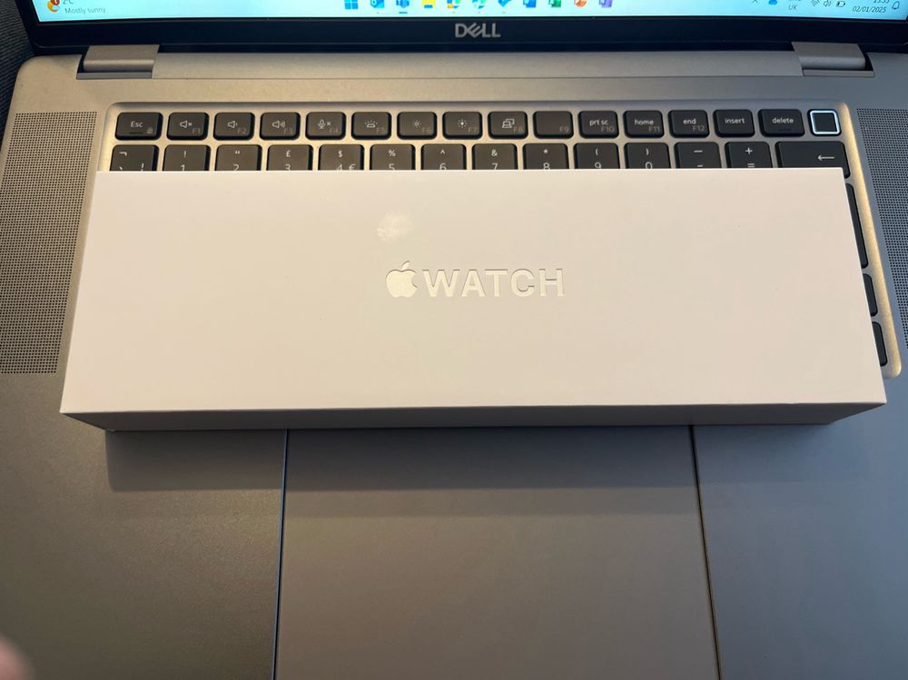 An Apple Watch box sat on a laptop keyboard
