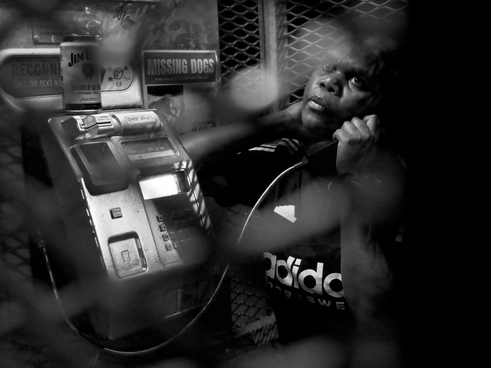 Marie, a 26-year-old Luritja woman, uses a payphone, late at night, to call her husband in prison. 