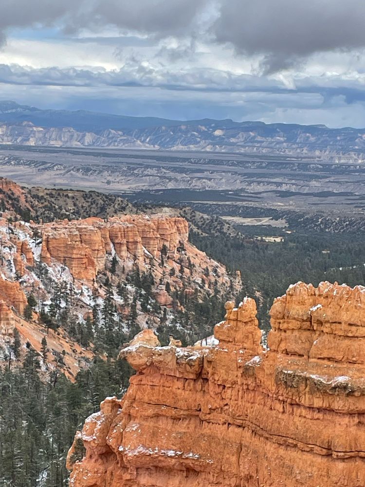Overlooking the hoodoos at Bryce Canyon. Red colored rock formations, deep canyons and snow covered pine trees