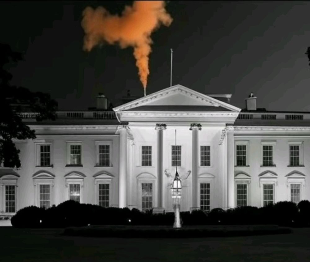 Plume of orange smoke coming from the top of the White House. 