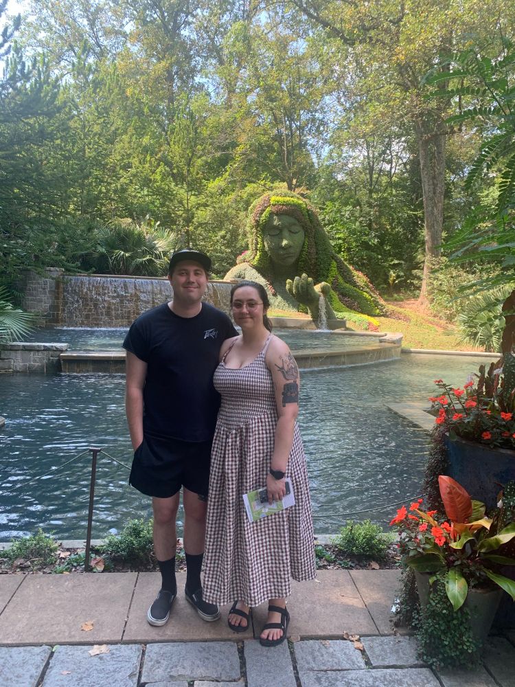 My partner Cade and I in front of a waterfall and a giant woman made from plants!! (She kinda reminded me of the island lady from Moana)