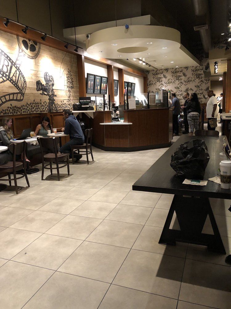 Starbucks 2019 with warm decor, wood chairs and a cozy vibe
