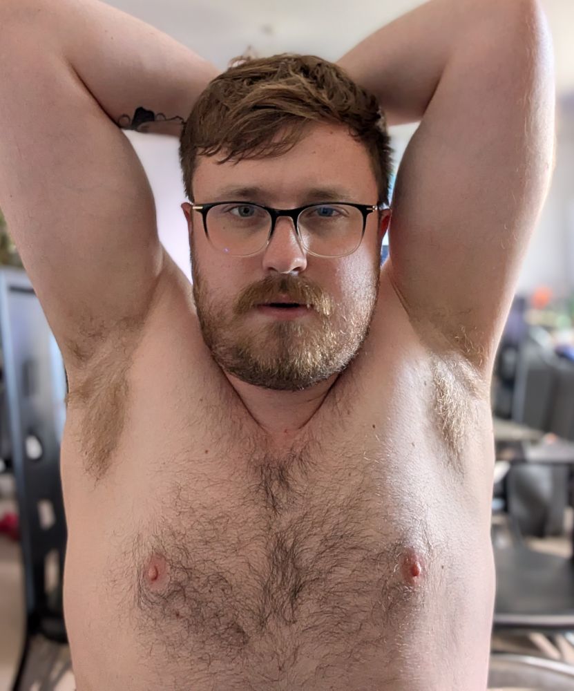 A topless man with hairy chest and pits showing. Some would say seductively.
