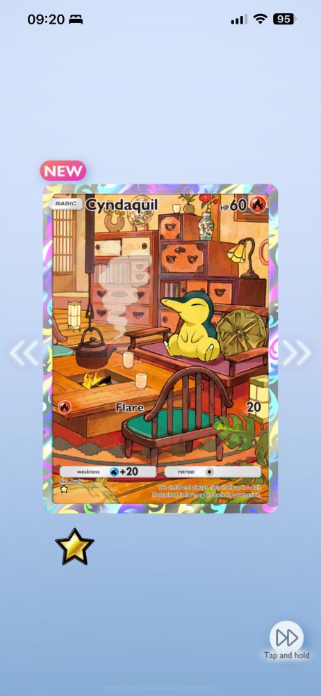 Screenshot of a Cyndaquil full art card in PTCGP, showing a peaceful Cyndaquil sitting on a bench in front of a fire with a tea kettle suspended above it