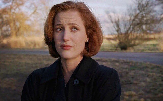 Scully with "done with your shit" facial expression. Looking to the side.