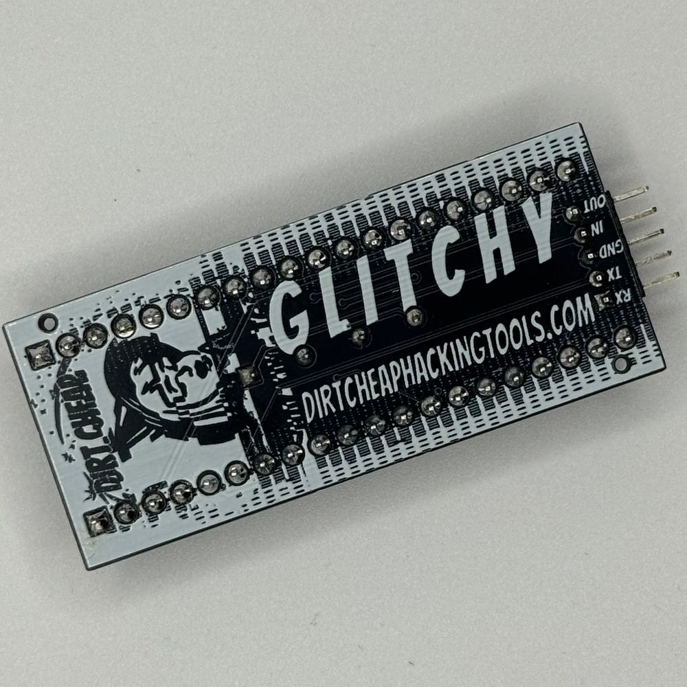 black and white circuit board with glitched dirt cheap hacking tools logo and glitchy solder mask art and "GLITCHY" and "dirtcheaphackingtools.com"