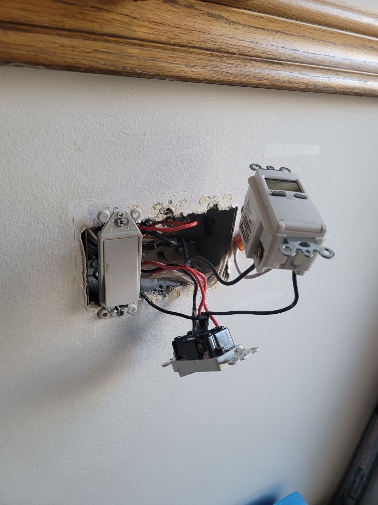 Photograph of an electrical box with the cover removed, and 2 of the 3 switches and several wires protruding at random angles. 