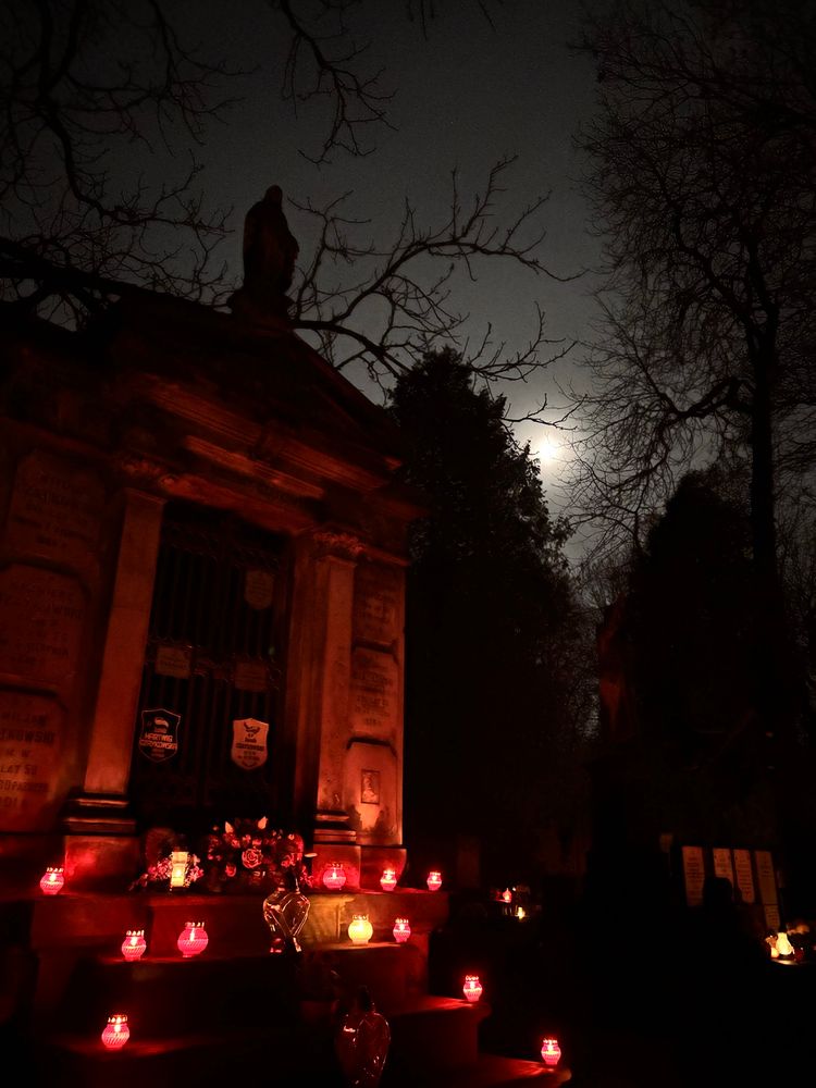 mausoleum with red candles, the moon is in the backround