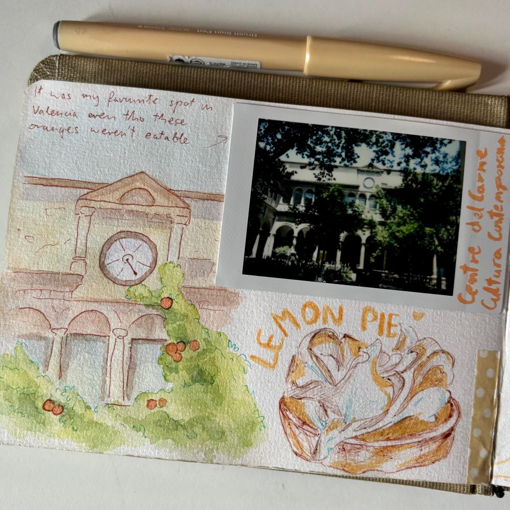 watercolor drawing of some building in valencia with a clock, there is a sketch of lemon pie and polaroid photo next to it