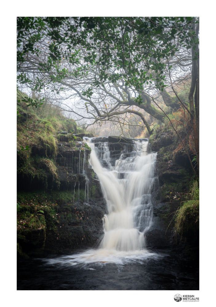 A Peak District waterfall on a misty autumnal morning