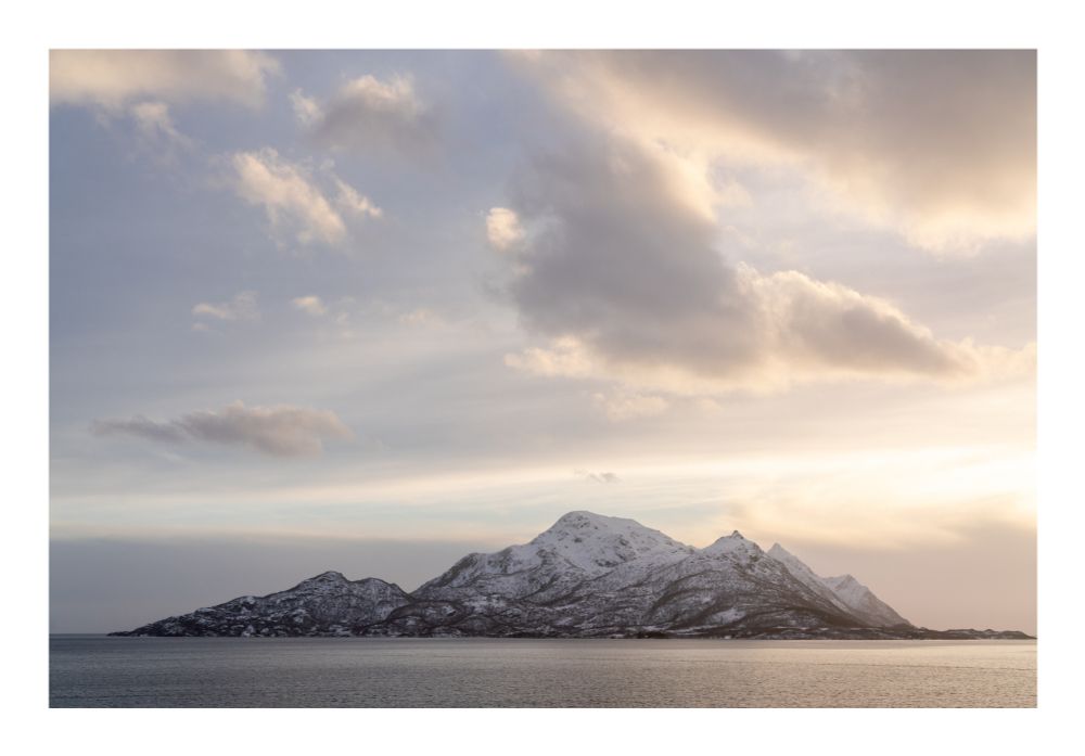 Golden light over an isolated mountain island. 