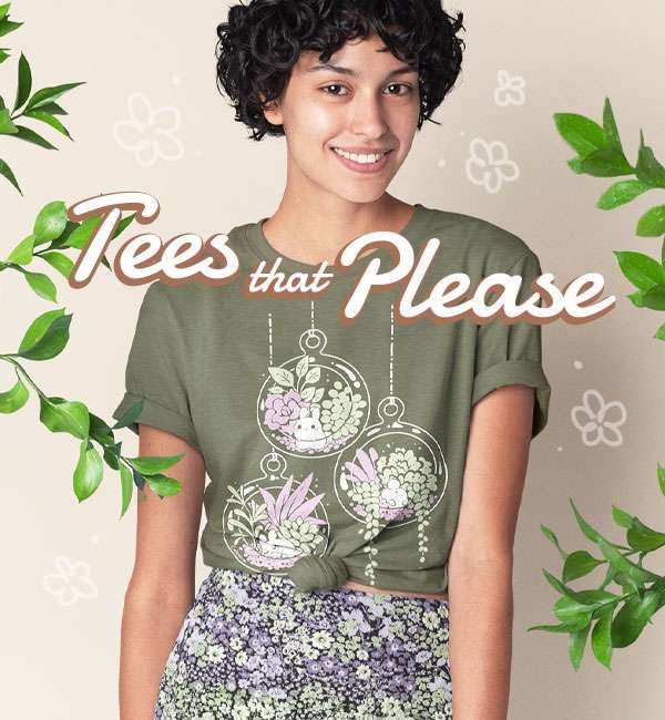 A photo of a woman with short, curly dark hair wearing a light olive green shirt, which features a print with terrarium globes filled with plants and each having a tiny bunny inside them. Some leafy branches frame her.