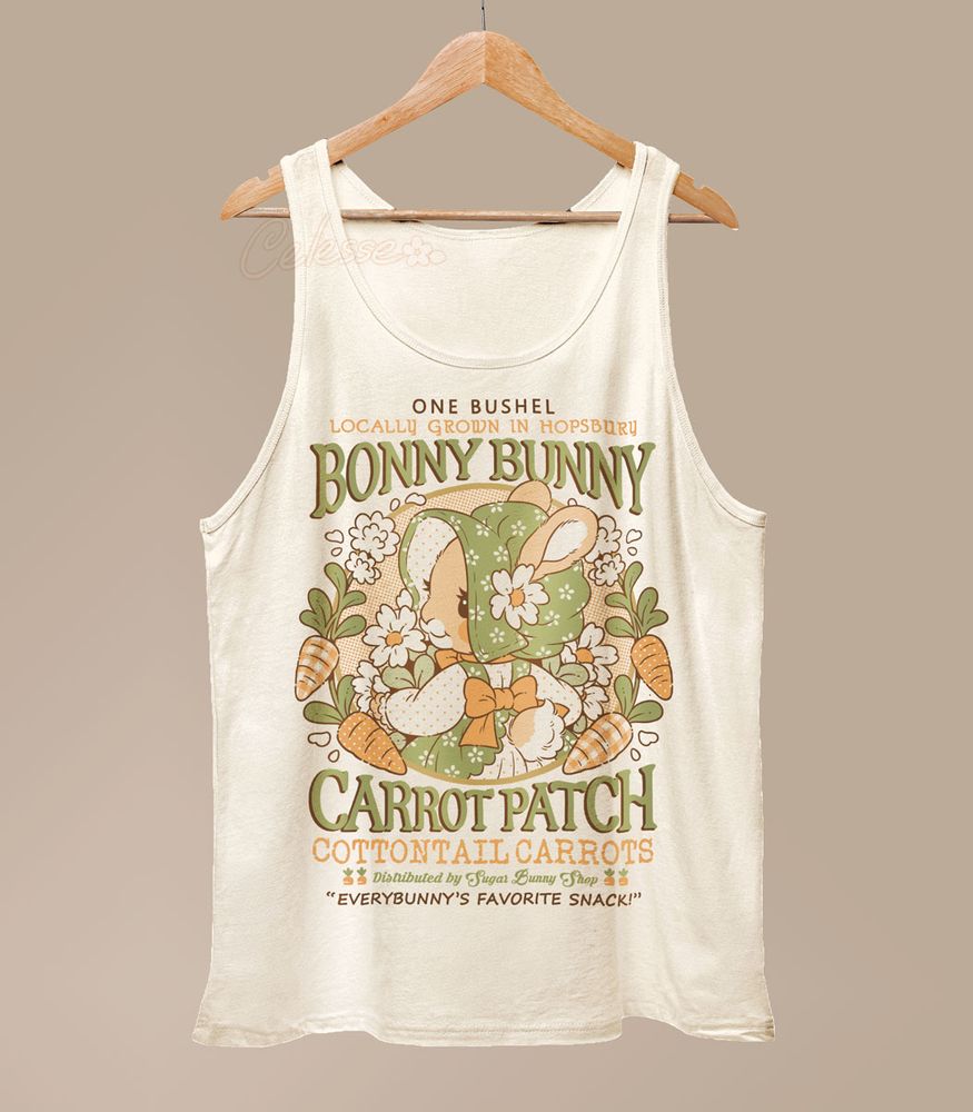 A photo of a tank top hanging from a wood hanger. The shirt is a natural color and the print features a faux logo for Bonny Bunny Carrot Patch, the center graphic showing a bunny wearing a bonnet and dress in a wreath of carrots.