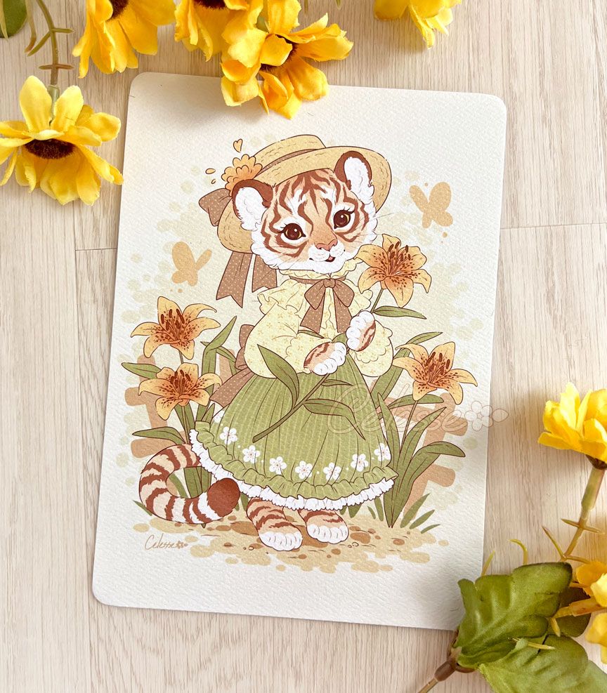 A photo of an art print featuring a tigress in a garden of tiger lilies and wearing a spring dress and straw hat