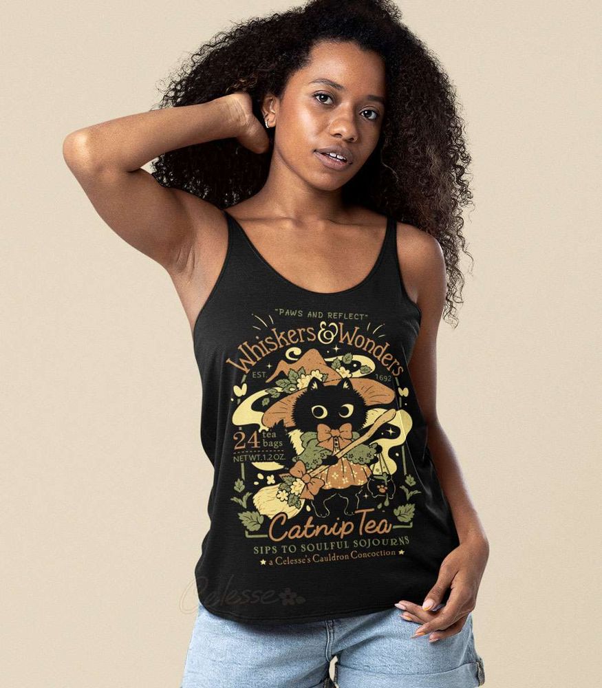 A photo of a woman posing in a black tank top with a print that features a faux logo for Whiskers & Wonders Catnip Tea, the graphic showing a black cat in a witch hat and dress holding a broom.