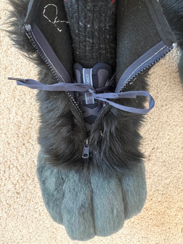 Fursuit paw built around a running shoe, zipper open.