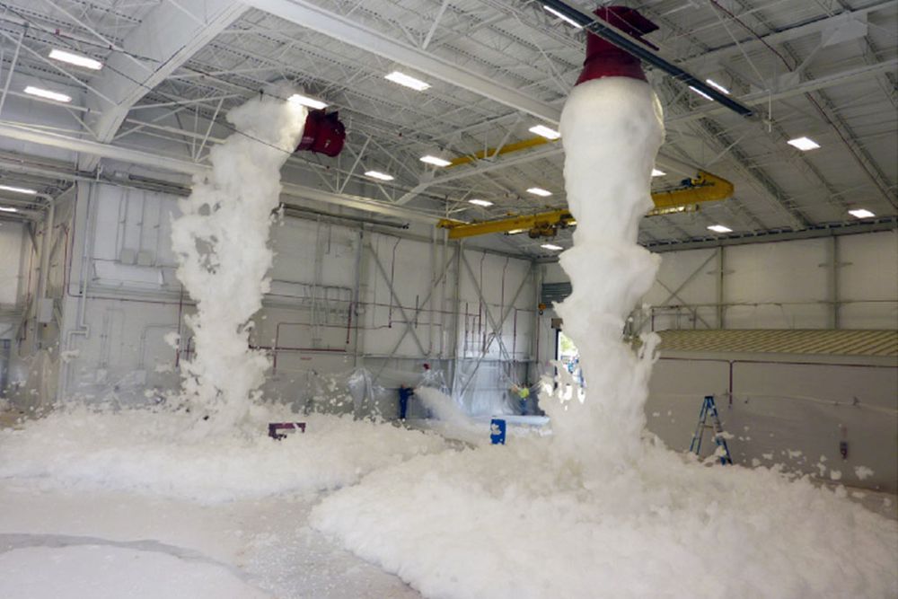 Fire retardant foam being sprayed in a hanger.