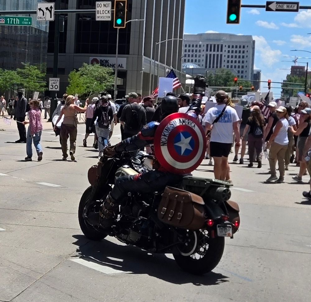 Captain America on a motorcycle with No Kings America written on his shield (Denver, CO)