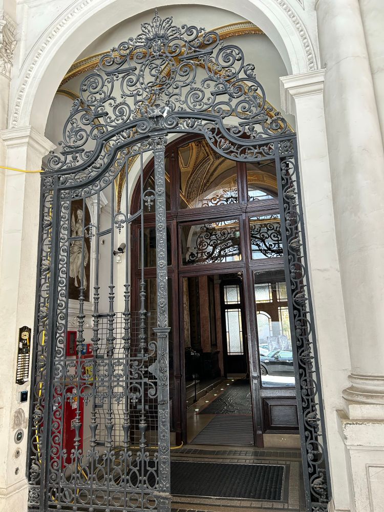 Fancy iron set of large doors with another glass set behind.