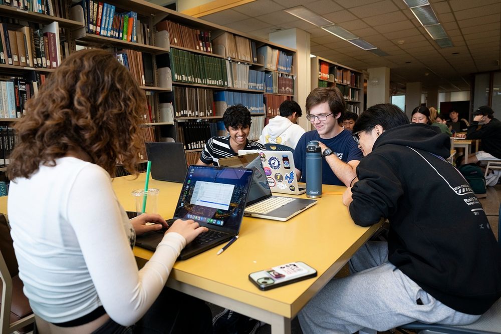 Students in the library on laptops.