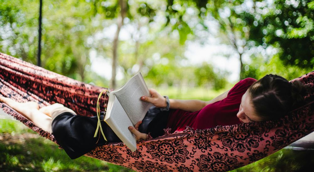 Reading in a hammock outdoors. Photo by Robert Norton on Unsplash.