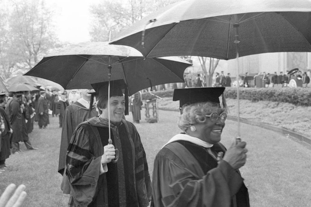 CMU faculty under umbrellas for the 1975 Commencement. Image from the University Archives.