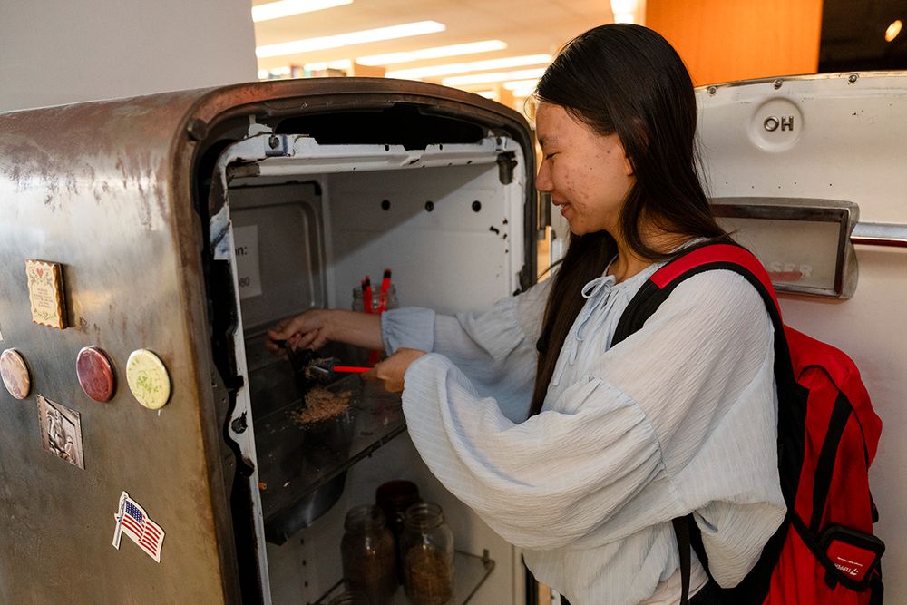 A student looking inside the fridge. Photo by Rebecca Devereaux.