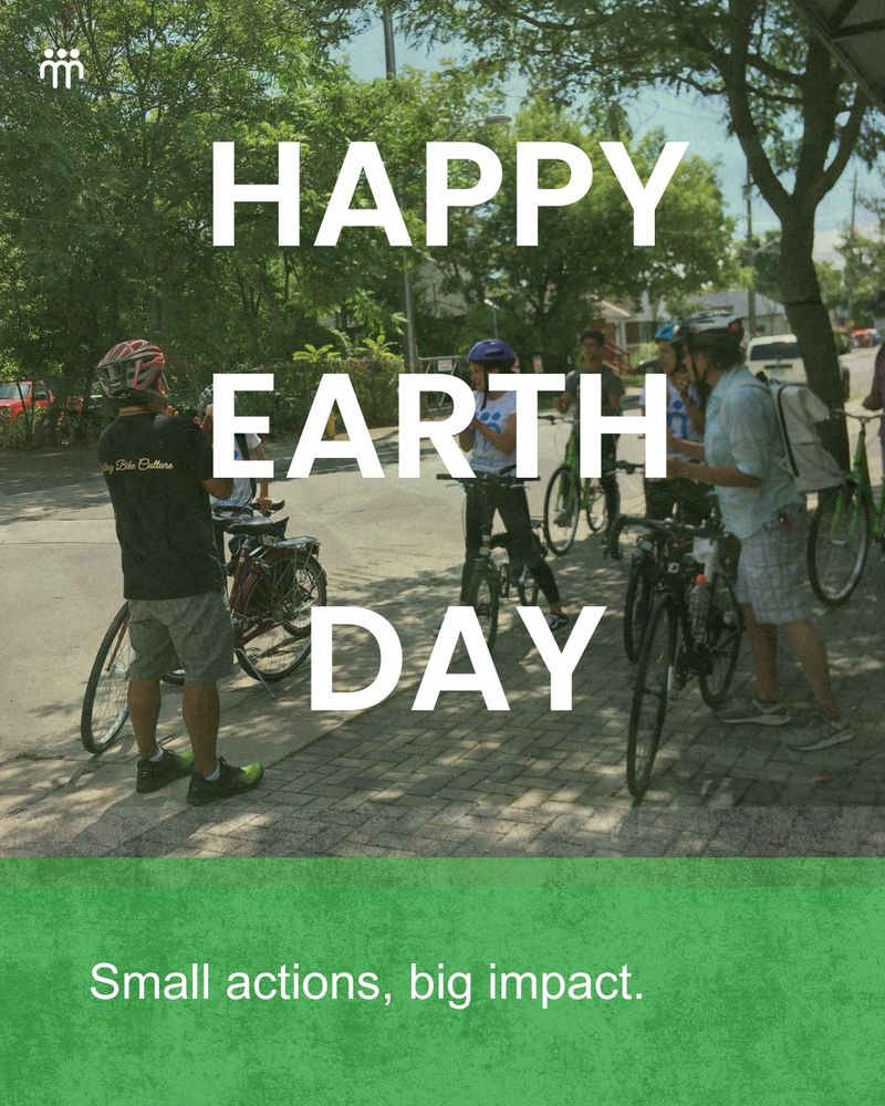 A group of people gather on a shaded street surrounded by trees, having a conversation with their bikes parked. Text overlaid reads “Happy Earth Day” and “Small actions, big impact.”