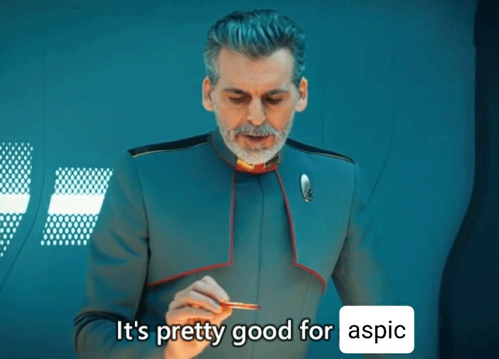 Admiral Just For Men from Star Trek Disco looking at an apple slice, the edited subtitle says "It's pretty good for aspic"
