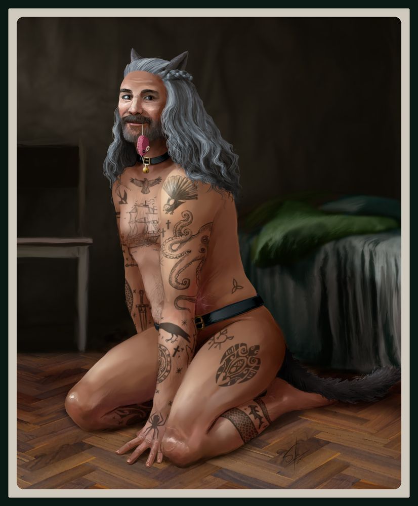 Edward Teach (Taika Waititi) from Our Flag Means Death kneeling on the floor wearing nothing but a pair of cat ears and a matching tail on a belt. He is smiling cheekily and has a catnip mouse hanging by the tail from his lips.
