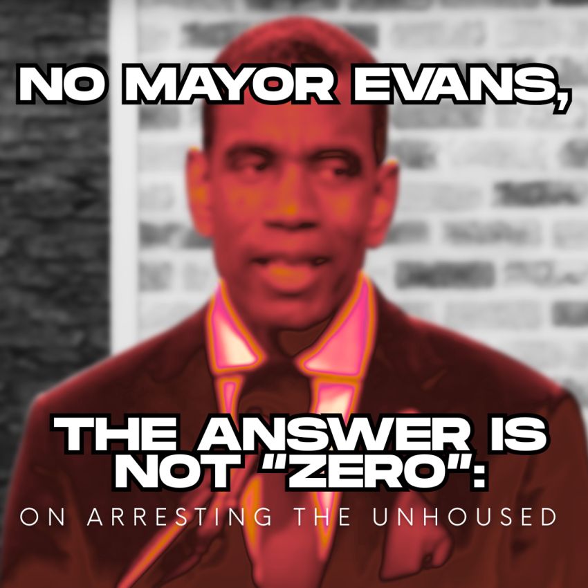 A man in a suit, Mayor Evans, speaking into a microphone while looking uncomfortable.