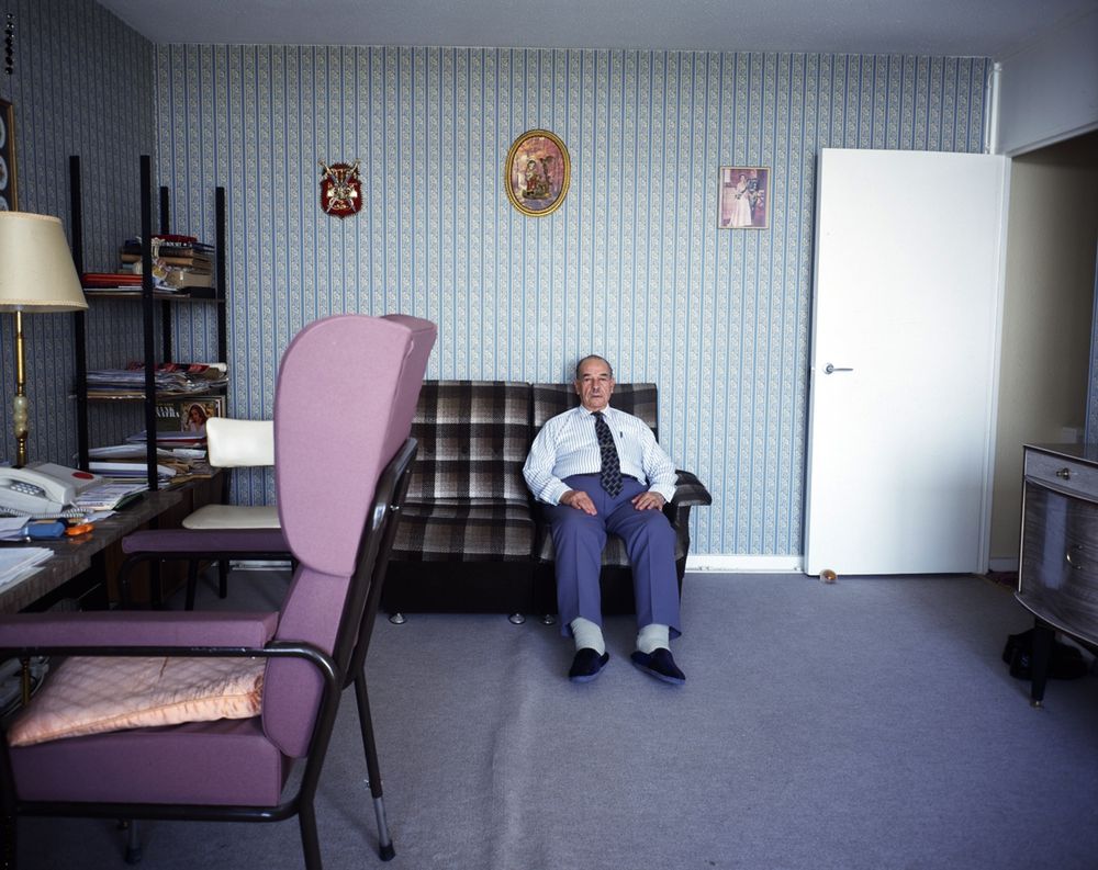 Photograph of a man on a sofa from series Holly Street Residents' by Tom Hunter © 1998