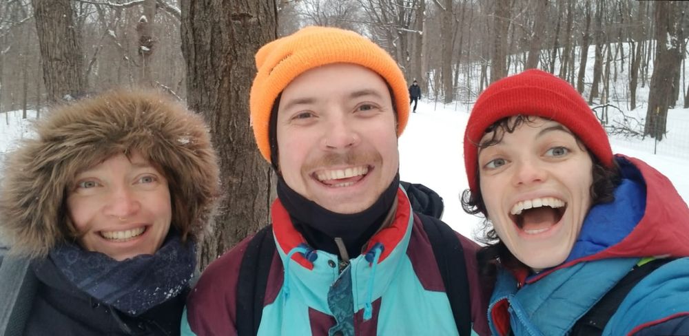 Three friends, Melina Nate and Maxine, with open mouth smiles in on snowy mount royal