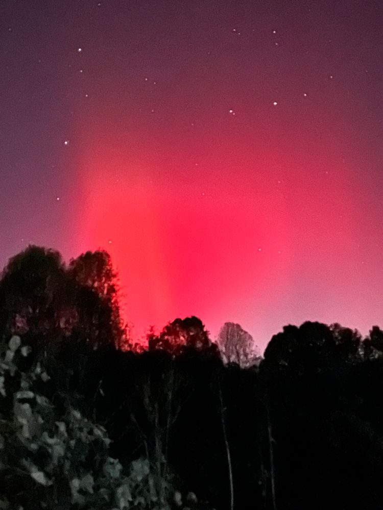 Orange, pink, purple, and white light up the night sky.