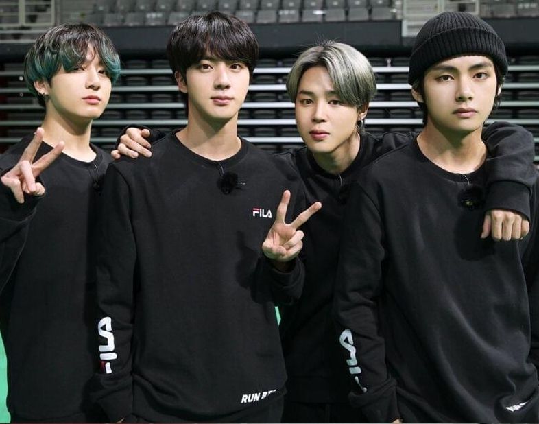 BTS vocalline, all dressed in black, looking serious, Jin and JK showing the V-sign.