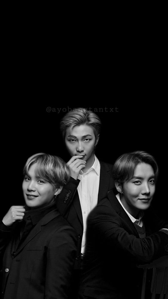 BTS rapline, a black and white photo,  all three wearing black suits, RM has his jacket open showing a white shirt.