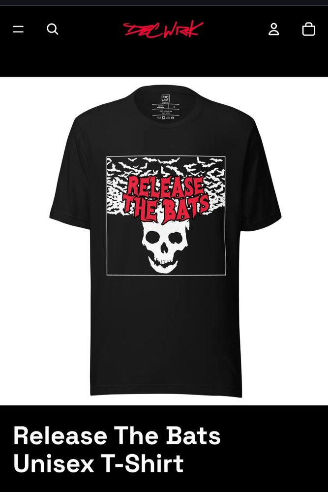 A black t-shirt with a white illustration of bats flying out of a skull with red text over it reading "Release the Bats".