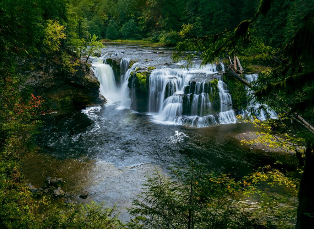 Lower Lewis Falls in Skamania Washington in the fall, with foliage just starting to turn red and orange