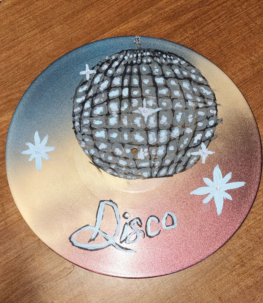 Spray painted color shift gradient vinyl record with a terribly hand painted disco ball. Some sparkly crystals for added effect. 