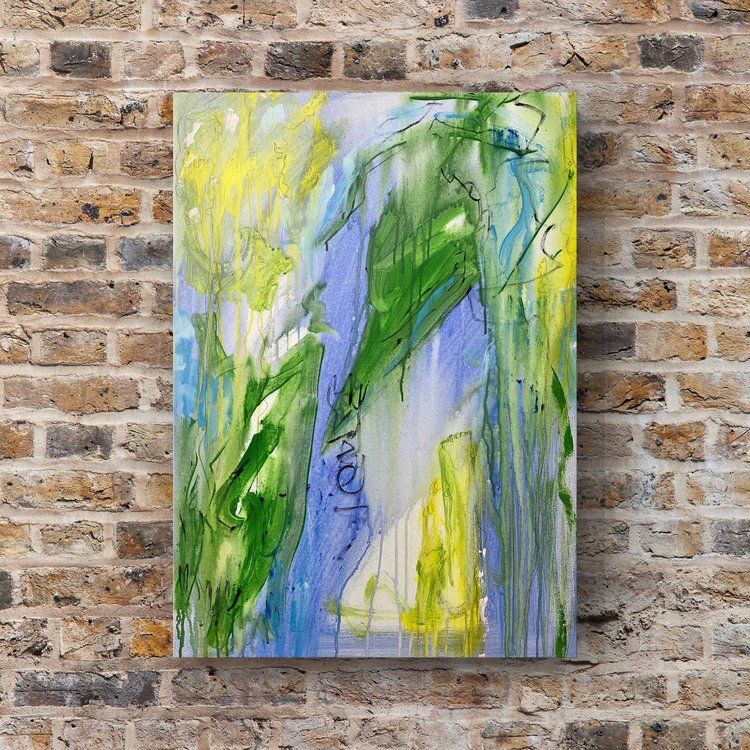 An abstract painting with vibrant brushstrokes in blue, green, and yellow hangs on a brick wall. 