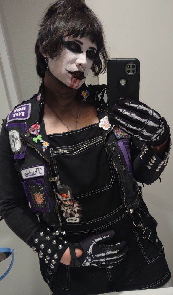 battle vest with dark circus and torture references all over