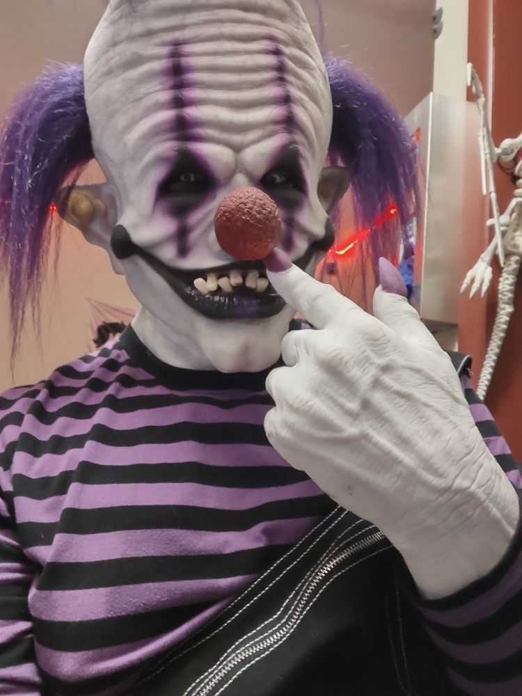 A weird silicone clown picking his nose and grinning down at you.  What a creep.  Bet he'll wipe it on you.