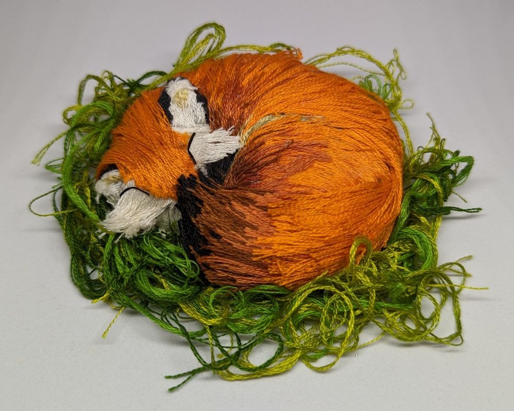 a sleeping fox made out of thread, different view