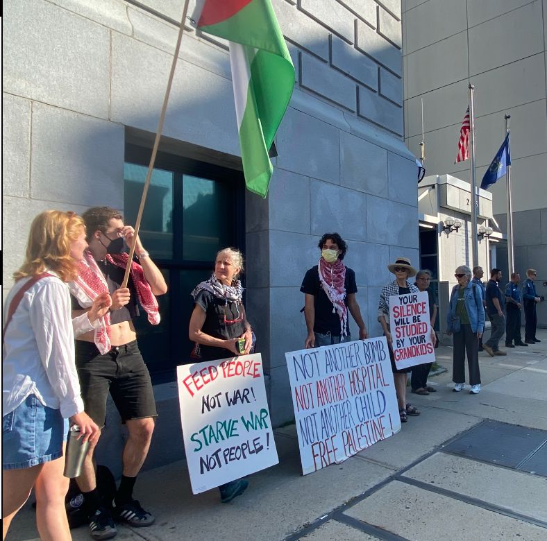 People holding signs near a court entrance 