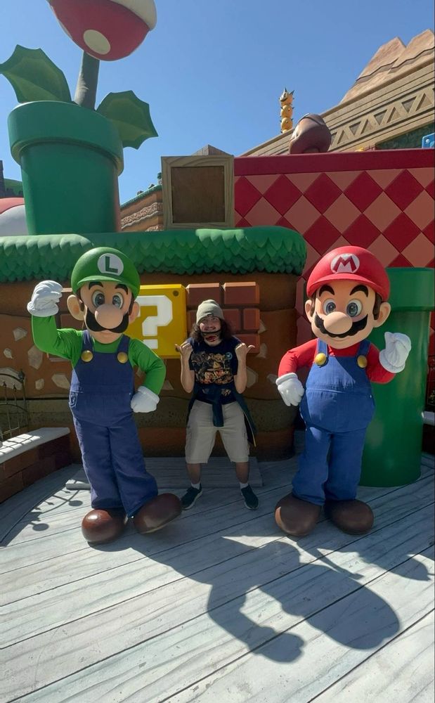 Me next to Mario and Luigi at Super Nintendo world 